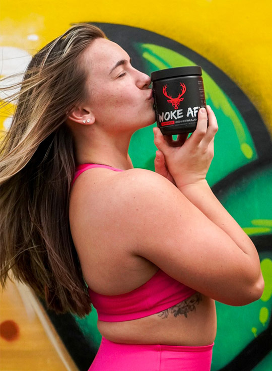Woman kissing the Bucked Up container. She truly enjoys the product.