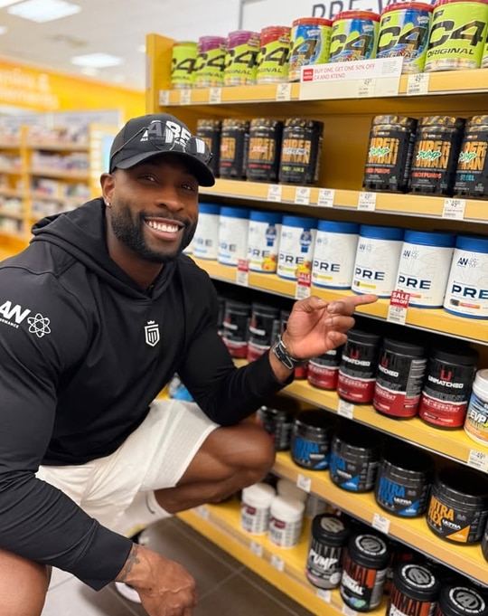 An athlete looking at Vitamin Shoppe products